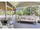 Cozy seating area on a screened porch with a view of the outdoor kitchen at 1167 Mossy Rock Dr, Summerville, SC 29485