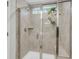 Walk-in shower with glass door and gray tiles, complemented by a small window at 1167 Mossy Rock Dr, Summerville, SC 29485