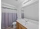Bright bathroom with wood cabinets, white countertop and shower with curtain at 1218 Cosmos Rd, Summerville, SC 29483