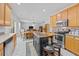A well-equipped kitchen features stainless steel appliances, center island, wood cabinets, and access to the living area at 1218 Cosmos Rd, Summerville, SC 29483