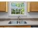 Kitchen sink with view to the backyard, stainless faucet and double basin sink at 1218 Cosmos Rd, Summerville, SC 29483