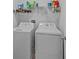 Convenient laundry room featuring a washer and dryer with shelving above at 1218 Cosmos Rd, Summerville, SC 29483