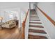 An elegant staircase with wood treads and white risers connects the home's living spaces at 1218 Cosmos Rd, Summerville, SC 29483
