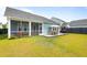 Beautiful backyard with a patio, dining set, and well-manicured lawn at 127 Archdale St, Summerville, SC 29486