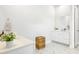 Modern bathroom with double vanity, white cabinets, tile floor, and woven hamper at 127 Archdale St, Summerville, SC 29486