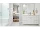 Bright bathroom with double vanity, tile floors and shower, and access to bedroom at 127 Archdale St, Summerville, SC 29486
