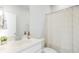 Clean, bright bathroom with white fixtures and a decorative shower curtain at 127 Archdale St, Summerville, SC 29486