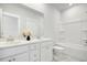 Bright bathroom with a double sink vanity, large mirror, and bathtub with shower at 127 Archdale St, Summerville, SC 29486