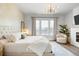Inviting bedroom with natural light, a decorative chandelier, and a comfortable queen-sized bed at 127 Archdale St, Summerville, SC 29486