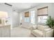 Bedroom area with a comfortable seating area and natural light from the exterior door and windows at 127 Archdale St, Summerville, SC 29486
