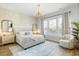Serene bedroom featuring a queen-size bed, decorative mirrors, and natural lighting from large windows at 127 Archdale St, Summerville, SC 29486