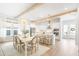 Bright and open floor plan with a dining area leading to a white kitchen with a center island at 127 Archdale St, Summerville, SC 29486