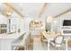 Bright kitchen with an attached dining area featuring a long table and bar seating at the kitchen island at 127 Archdale St, Summerville, SC 29486