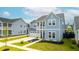 Beautiful two-story blue home featuring a front porch, garage, and landscaped front yard at 127 Archdale St, Summerville, SC 29486