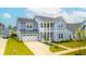 Attractive two-story home with an attached two-car garage and a well-maintained front yard at 127 Archdale St, Summerville, SC 29486