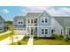 Charming two-story blue home with a welcoming front porch and well-manicured lawn at 127 Archdale St, Summerville, SC 29486