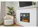 Comfortable sitting area with fireplace, TV, accent chair, and large potted plant at 127 Archdale St, Summerville, SC 29486