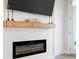 Close-up view of a modern fireplace with a wooden mantel and decorative accents at 127 Archdale St, Summerville, SC 29486