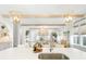 Bright open kitchen featuring white cabinets, stainless steel appliances, large island, and open floor plan at 127 Archdale St, Summerville, SC 29486