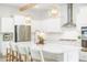 Well-lit kitchen featuring an island with seating and modern stainless steel appliances at 127 Archdale St, Summerville, SC 29486