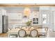 Modern kitchen with an island, stainless steel appliances, and open dining area at 127 Archdale St, Summerville, SC 29486