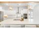 A kitchen with white cabinets, stainless steel appliances, double ovens, and a large island at 127 Archdale St, Summerville, SC 29486