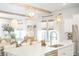 Bright kitchen with white cabinets, stainless steel appliances, large island, and dining area at 127 Archdale St, Summerville, SC 29486
