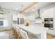 Modern kitchen with island seating, stainless steel appliances, and sleek white cabinetry at 127 Archdale St, Summerville, SC 29486