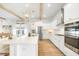 Bright open kitchen with a large island, stainless steel appliances, and modern lighting at 127 Archdale St, Summerville, SC 29486