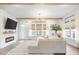 Bright living room featuring a fireplace, hardwood floors, and a comfortable, large sectional sofa at 127 Archdale St, Summerville, SC 29486