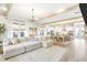 Open-concept living and kitchen area with hardwood floors, exposed beams, and stylish dining set at 127 Archdale St, Summerville, SC 29486