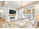 Comfortable living room with a fireplace, mounted TV, and large windows with woven blinds at 127 Archdale St, Summerville, SC 29486