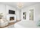 Bright main bedroom features a fireplace, TV, modern lighting, and ensuite access at 127 Archdale St, Summerville, SC 29486