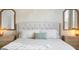 Close-up view of a king bed with decorative pillows, side tables, and lamps in the main bedroom at 127 Archdale St, Summerville, SC 29486