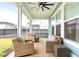 Covered outdoor patio with seating area and ceiling fan for relaxing outdoors at 127 Archdale St, Summerville, SC 29486