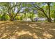 Spacious backyard with mature trees, a shed, and a charming home with a deck perfect for outdoor living at 1303 Teal Ave, Charleston, SC 29412
