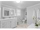 Bright bathroom featuring a white vanity, tile flooring, and a wall mirror at 1303 Teal Ave, Charleston, SC 29412