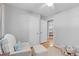Bright Bedroom with wood floors, a white chair, and a glimpse into another bedroom at 1303 Teal Ave, Charleston, SC 29412