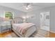 Calming bedroom with a ceiling fan, a light pink comforter, and hardwood floors at 1303 Teal Ave, Charleston, SC 29412