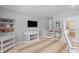 Versatile bonus room with a television, neutral color scheme, and a view into the other rooms at 1303 Teal Ave, Charleston, SC 29412