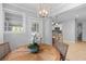The dining area has a view into the white kitchen with a breakfast bar and pendant lighting at 1303 Teal Ave, Charleston, SC 29412