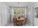 Cozy dining area featuring a round table, stylish chairs, and a modern light fixture beneath a window at 1303 Teal Ave, Charleston, SC 29412
