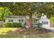 Charming single-story white brick home with lush landscaping and a quaint front yard tree at 1303 Teal Ave, Charleston, SC 29412