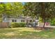 Quaint brick home featuring an American flag, mature trees, and a well-maintained front lawn at 1303 Teal Ave, Charleston, SC 29412