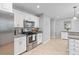 Modern kitchen with stainless steel appliances, granite counters, white cabinets and tile flooring at 1303 Teal Ave, Charleston, SC 29412