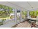 Enclosed sunroom featuring lots of light and access to a backyard deck at 1303 Teal Ave, Charleston, SC 29412