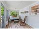 Cozy sunroom with white brick and access to the backyard at 1303 Teal Ave, Charleston, SC 29412