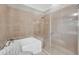 Bathroom featuring a glass enclosed shower, a soaking tub, and neutral toned tiles at 136 Cooper River Dr, Mount Pleasant, SC 29464