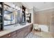 Stylish bathroom featuring a bathtub with tile surround, a spacious vanity, and elegant decor at 136 Cooper River Dr, Mount Pleasant, SC 29464