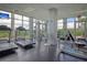 Well-equipped gym with modern equipment and large windows providing natural light and views, promoting a healthy lifestyle at 136 Cooper River Dr, Mount Pleasant, SC 29464